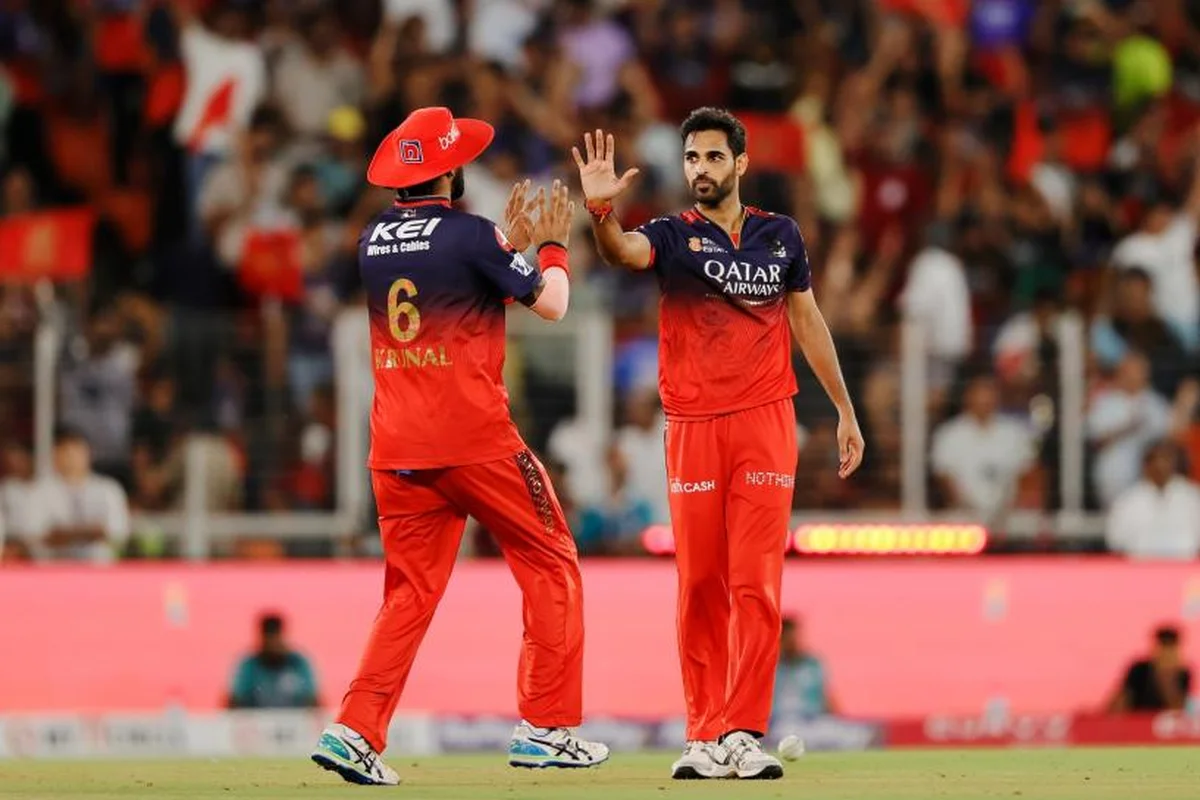 Bhuvneshwar Kumar celebrating a wicket with RCB teammates during IPL 2026