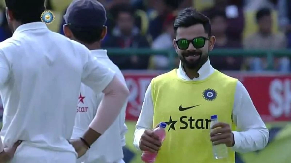 A 12th man carrying drinks to the pitch