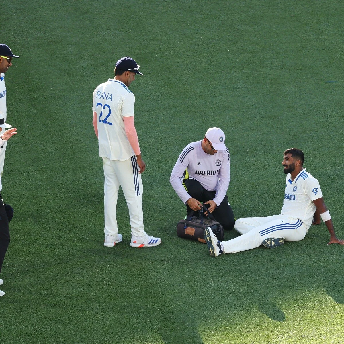 An Indian fast bowler holding his back in pain — the price of bowling 150kmph across 11 months of cricket
