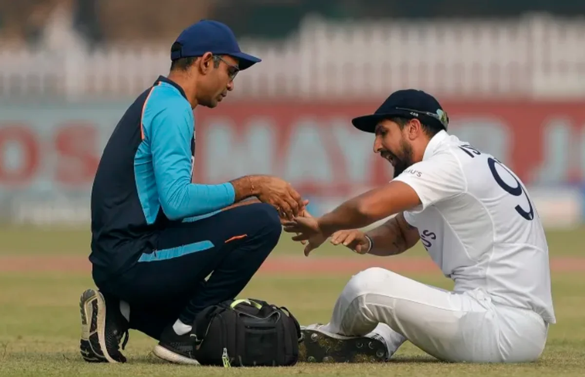 A cricket physio treating a bowler on the field — the medical team that works harder than anyone in Indian cricket